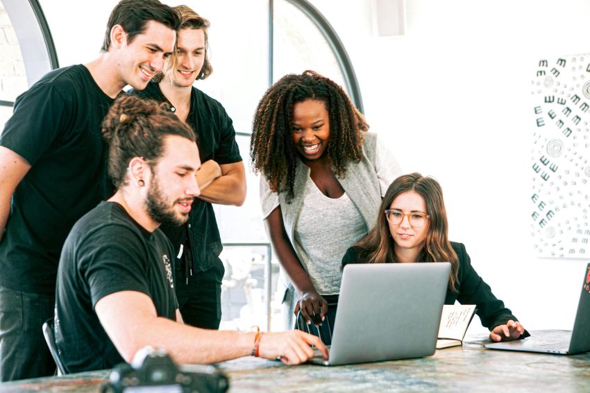 Startup members on a laptop checking their website