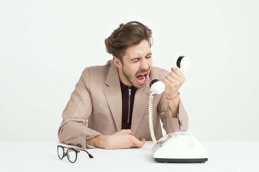 An irate customer calling through his phone 