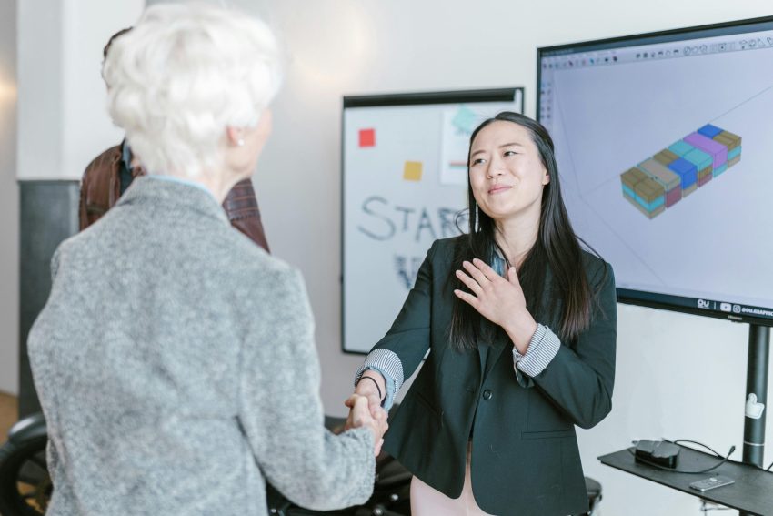 A startup founder shaking the hands of an investor