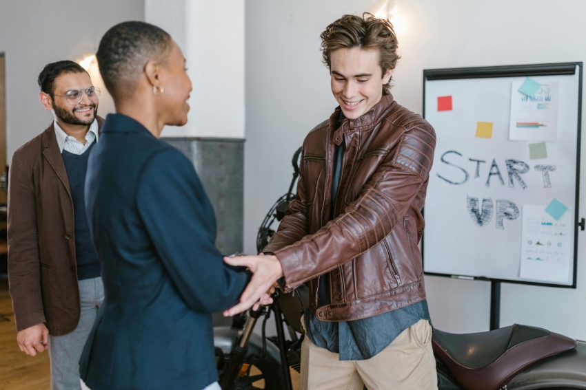 An investor shaking the hands of a startup founder
