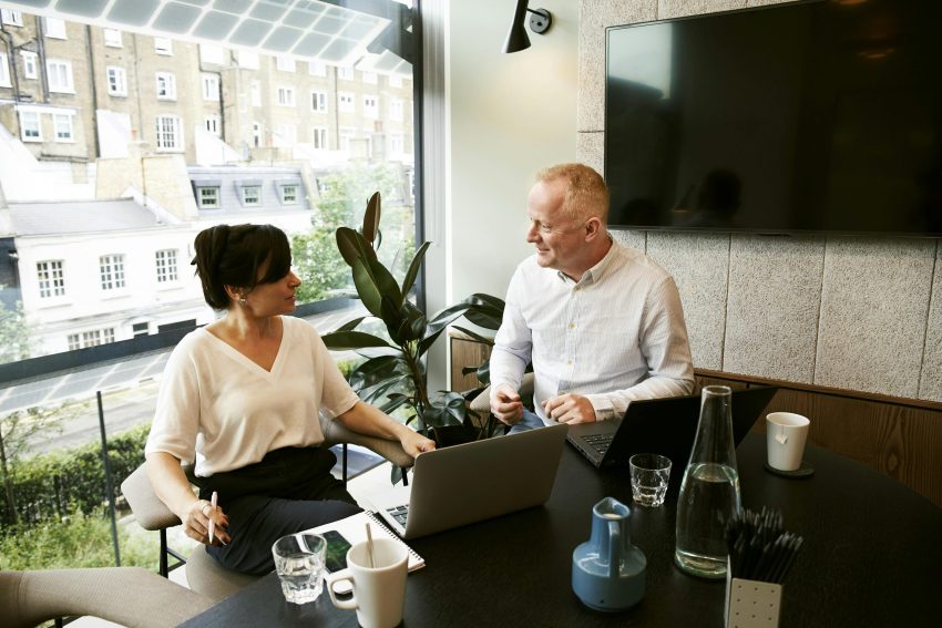 Founders of a digital marketing company discussing in their office