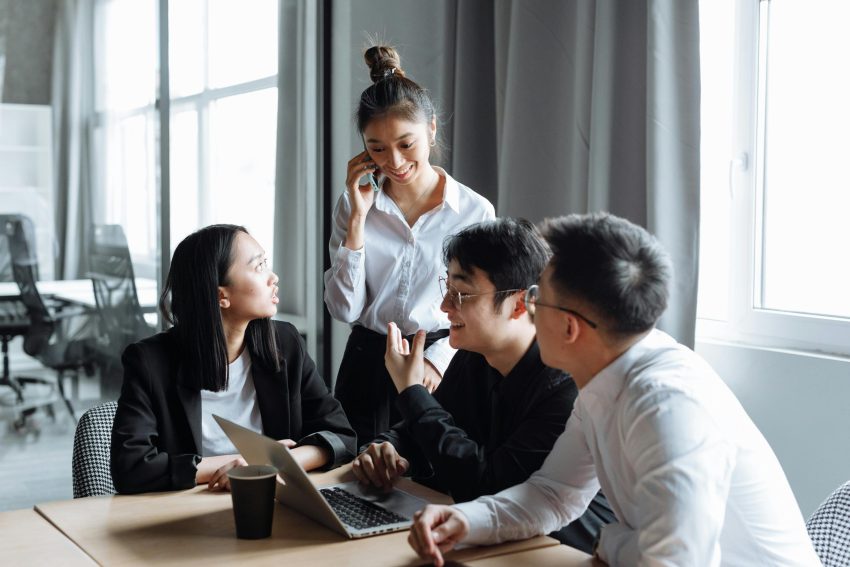 Startup employees checking a document on a laptop